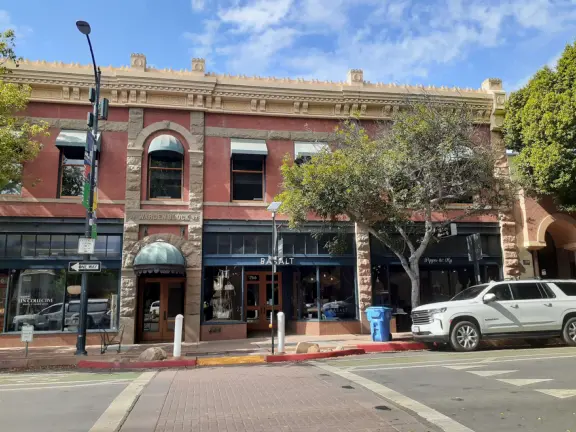 A main street of late 19th century storefronts, popular cafes, and a hip college scene. Recently, suffering an epidemic of homelessness relating to mental health problems.