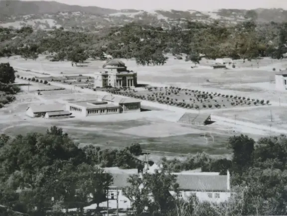 Sunny town with a cute main street, and City Hall with beautiful Sunken Garden with sculptures, tall old trees including magnolia trees, and fountains.