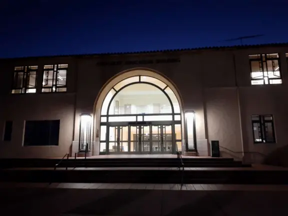 Hilly, sunny campus with tall, impressive trees and green lawns. A hands-on learning university.