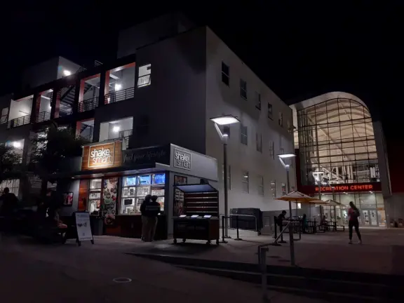 Hilly, sunny campus with tall, impressive trees and green lawns. A hands-on learning university.