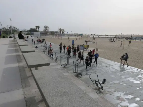 A flat, straight beach with a wide boardwalk where fitness reigns supreme! It reminded me of Venice Beach in California.