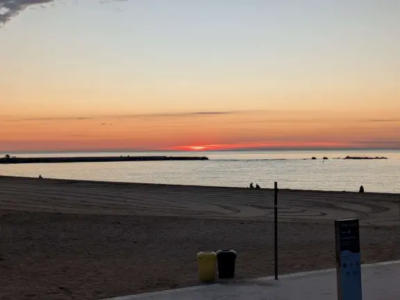 A flat, straight beach with a wide boardwalk where fitness reigns supreme! It reminded me of Venice Beach in California.