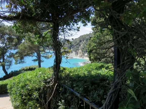Stunning, hilly gardens over the sea, with orange trees, cypress trees, wisteria, arbors, and statues.