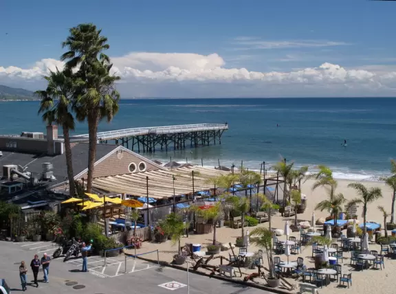 Eat at a cafe with your feet in the sand looking out at the sea in a sheltered outdoor area- magical!