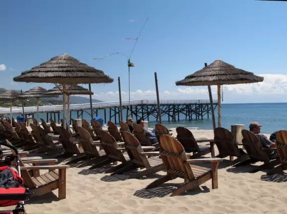 Eat at a cafe with your feet in the sand looking out at the sea in a sheltered outdoor area- magical!
