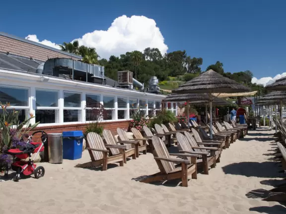 Eat at a cafe with your feet in the sand looking out at the sea in a sheltered outdoor area- magical!