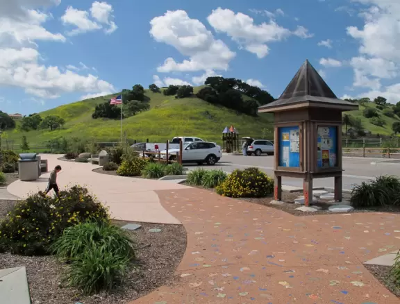 A wooden castle playground with gingerbread house, medieval towers, slides, bridges, monkey bars, rope bars, swings of all sorts, mist maker, viking ship, windmill, wild west town, rock-climbing wall, and tire swing.