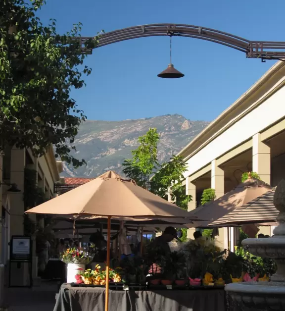 A pretty mall filled with flower pots and giant sized games, with views of the mountains and plenty of stores for kids!