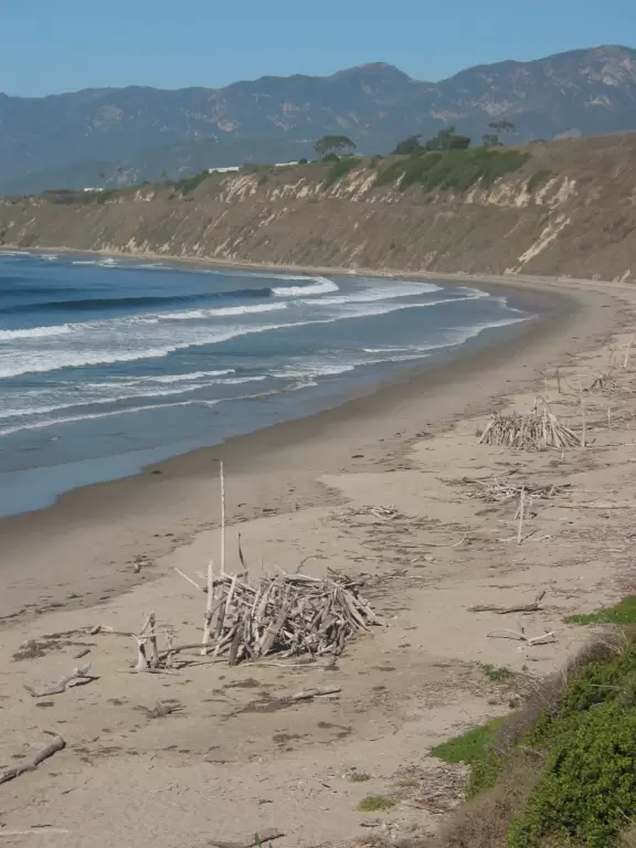 Wide desolate beach, backed by high cliffs- prettiest from above.