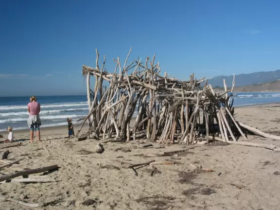 Wide desolate beach, backed by high cliffs- prettiest from above.