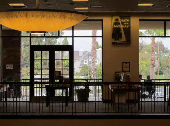 Shopping center close to the freeway, with a Barnes and Noble Bookstore and some cafes with flower planters and space outside where kids can run around.
