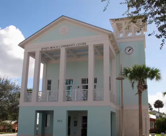 Main block with tropical-themed cafes and views of the water, plus a coffee shop and gift shops in little houses.