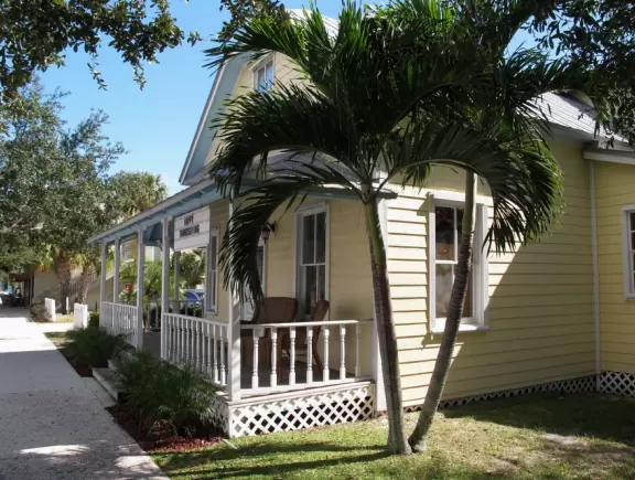 Main block with tropical-themed cafes and views of the water, plus a coffee shop and gift shops in little houses.