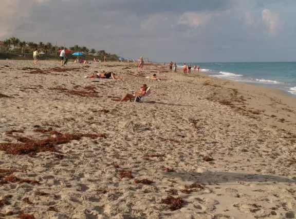 Beach with cute pier and aquamarine water.