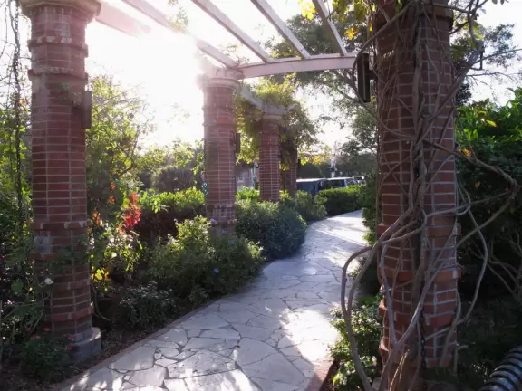 Gorgeous main street with large, European-style park where people sit on the grass by the fountain.