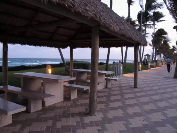 Fun stretch of beach with attractive, popular boardwalk, grass by the sand, and little coves built along the shore with rocks.