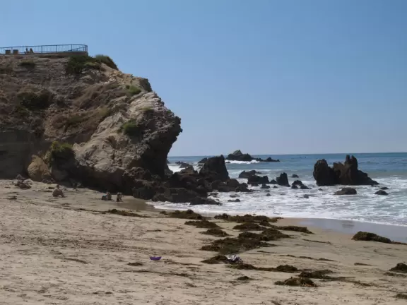 Walk a steep path with lovely views down to a popular beach where kids play in the sand and bodyboard.