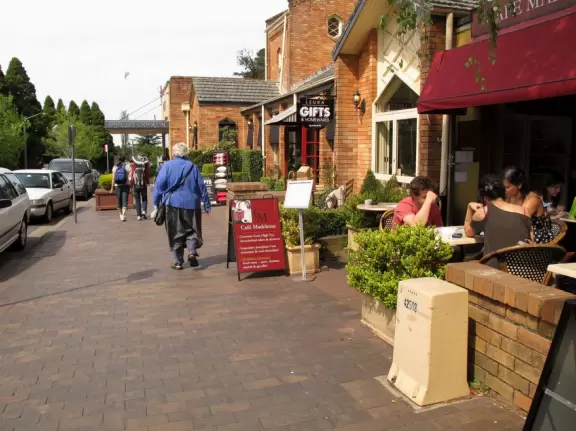 Delightful town with French cafes and bakeries, and residential streets overflowing with flowers and greenery.