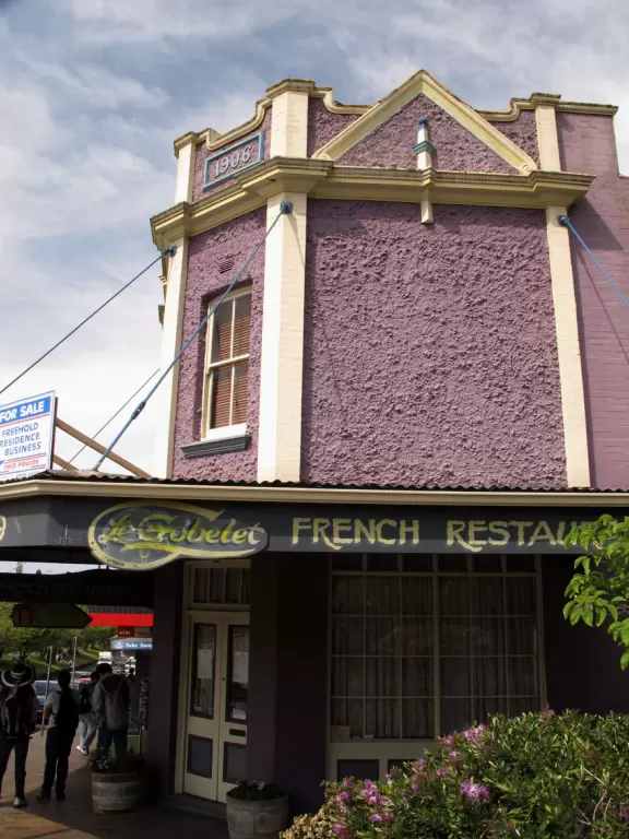 Delightful town with French cafes and bakeries, and residential streets overflowing with flowers and greenery.