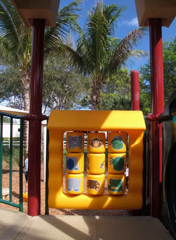 Tropical park with sky-high playground for older kids, toddler playground, fitness trail and stations, pale-lime gazebo, and spiffy basketball courts.