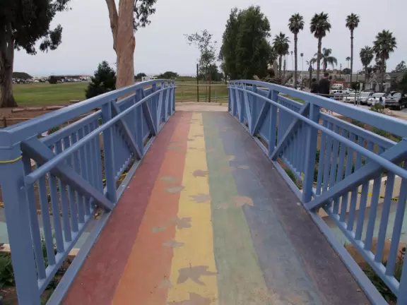 Modern playground with Chumash Indian huts and canoe, seals and whales to climb, roller slide, rainbow bridge, and bald eagle in a nest.