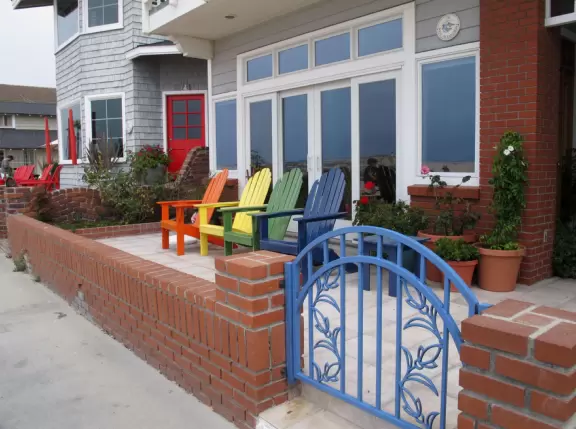 Outdated area with ferris wheel, carousel, boardwalk between beachhouses and the beach, pier, and nice walking path along the harbor.