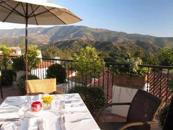 A magical place set upon hills with huge majestic oaks, shimmering green lawns, and exquisite Spanish architecture and decor, all backed by Ojai's mountains.