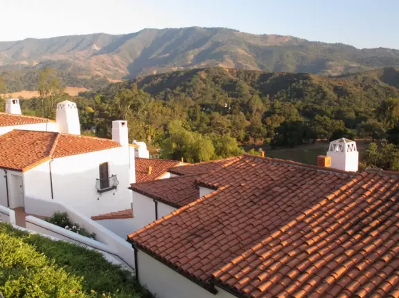 A magical place set upon hills with huge majestic oaks, shimmering green lawns, and exquisite Spanish architecture and decor, all backed by Ojai's mountains.