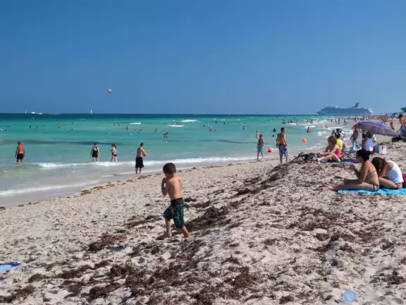 Gorgeous ocean colors, fun crowd of families, shallow water with little bouncy waves.