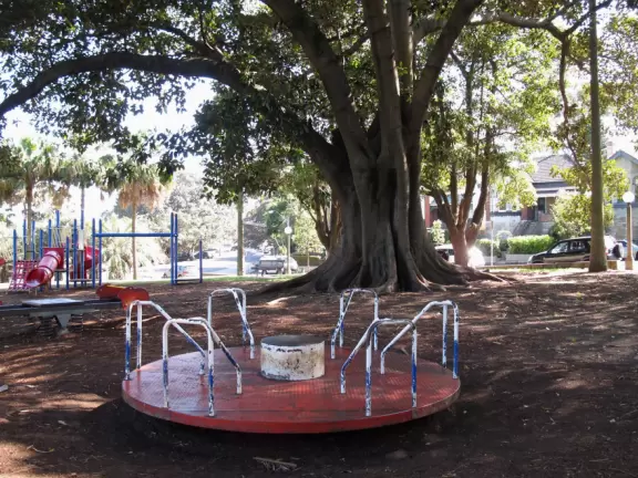 Birds sing a thousand melodies in the huge Moreton Bay fig trees while happy people stroll along the walkway at this waterfront park.
