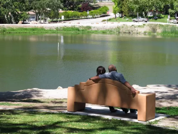 A large park with beautiful tall trees, playground with huge slides, gazebo, and a pleasant lake where you can rent paddle boats in summer.