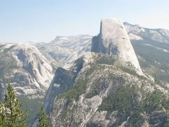 Breathtaking side-on view of half dome, three waterfalls, and the entire stunning valley.