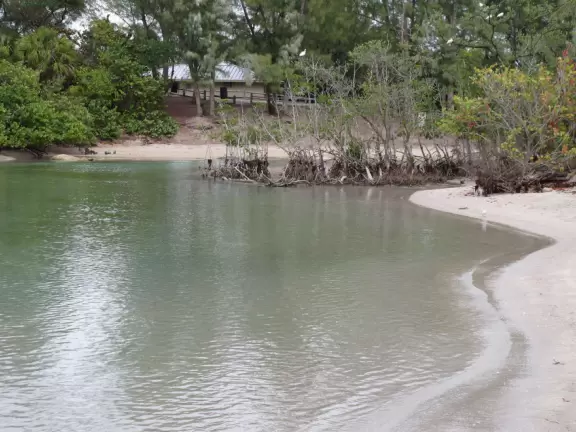 Large lagoon with clear water where kids can swim, tons of shade, and playground in the sand.