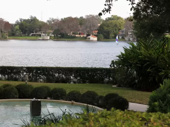 Gorgeous main street with large, European-style park where people sit on the grass by the fountain.