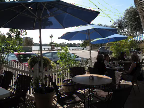 A main strip in Orlando with restaurants, across the street from the lake.