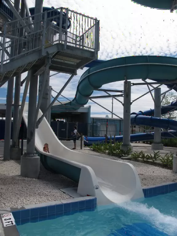 Colorful waterpark with lovely lazy river, two tall slides, and water playground with guns, huge bucket of water, and small slides. Beware the biting ants!