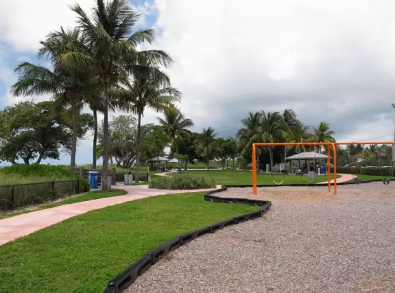 Paradise! A rare white sand beach in the Keys, with water of many shades of blue, and an ultra-modern playground amongst coconut trees with shaded huts.