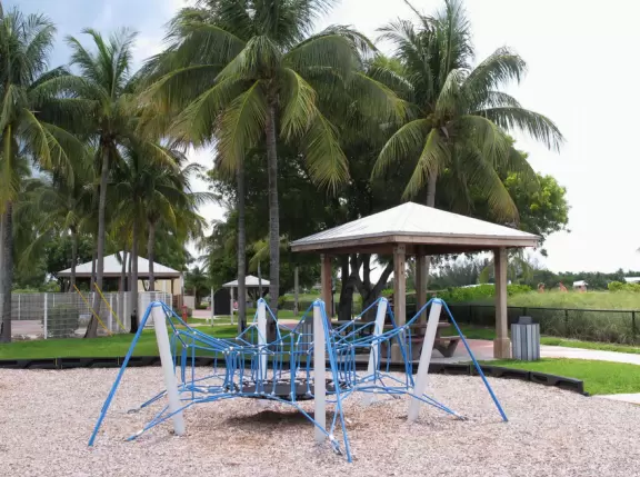 Paradise! A rare white sand beach in the Keys, with water of many shades of blue, and an ultra-modern playground amongst coconut trees with shaded huts.