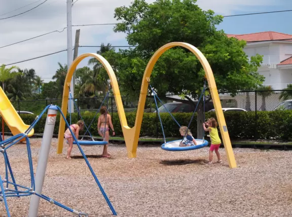 Paradise! A rare white sand beach in the Keys, with water of many shades of blue, and an ultra-modern playground amongst coconut trees with shaded huts.
