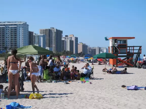 Gorgeous ocean colors, fun crowd of families, shallow water with little bouncy waves.