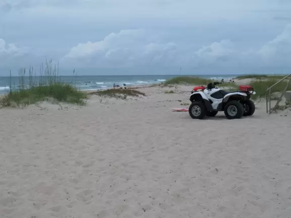 Pleasant wide-open beach with fine pale sand and pretty water.