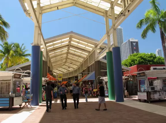 A touristy waterfront mall with restaurants and stalls with souvenirs.