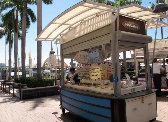 A touristy waterfront mall with restaurants and stalls with souvenirs.