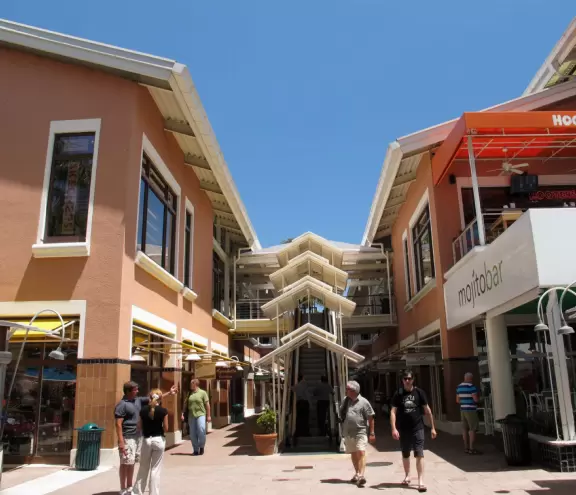 A touristy waterfront mall with restaurants and stalls with souvenirs.