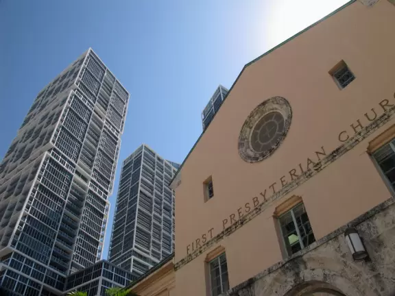 Unique glass skyscrapers reaching up to the perfect blue sky.