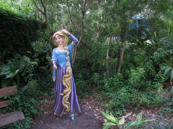 Whimsical sculptures of fairy tale scenes in the middle of a giant oak forest with Spanish moss and vines. Magic!