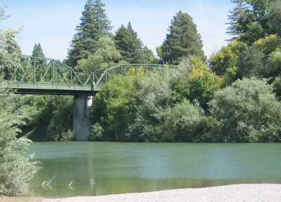 A wide, pebbly shore where you can enter the Russian River on kayak or paddleboat, have a beer, or walk the historic Guerneville Bridge.